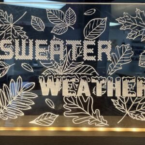 Acrylic light with base that says sweater weather